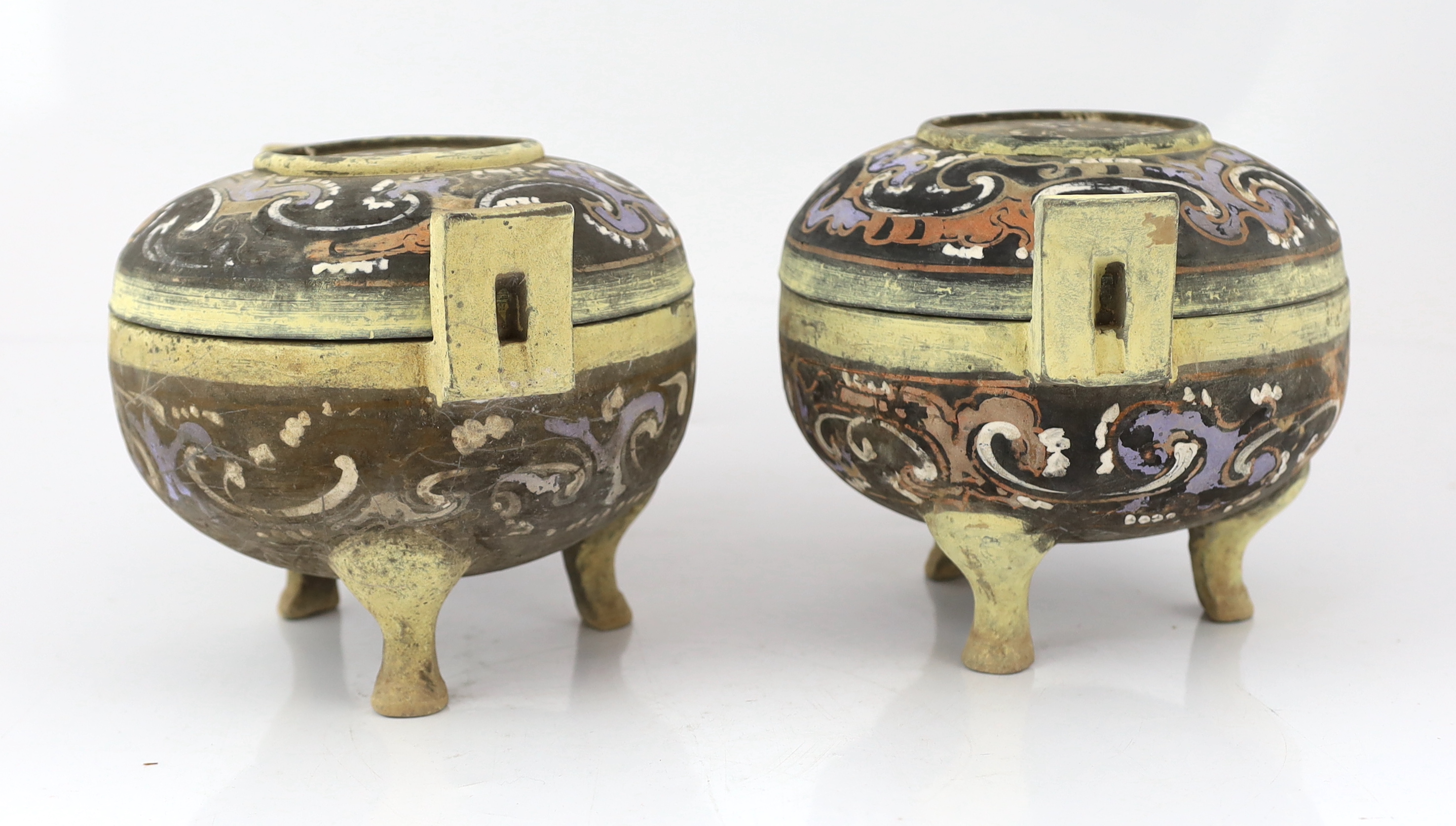 A pair of Chinese polychrome pottery ritual tripod vessels and covers, ding, Han dynasty (202BC - 220AD)